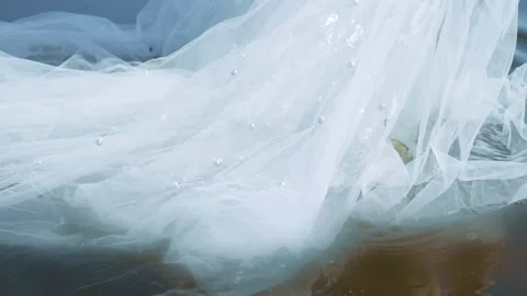 Close skirt pulls on water where back girl reflects in lake 스톡 동영상 104960416