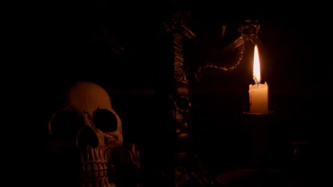 Close up of skull and background lit by candle and lightening Stock Footage 114230504