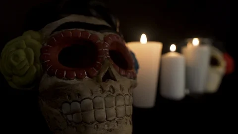 Close up to Skull with three candles light up on the back Stock Footage 96477293