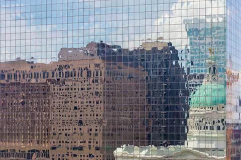 Close up of skyscraper with buildings reflecting in the windows Stock Photos