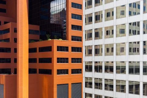 Close up of skyscraper with buildings reflecting in the windows Stock Photos