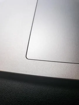 Close-up of a sleek silver laptop touchpad, showcasing modern technology design Stock Photos