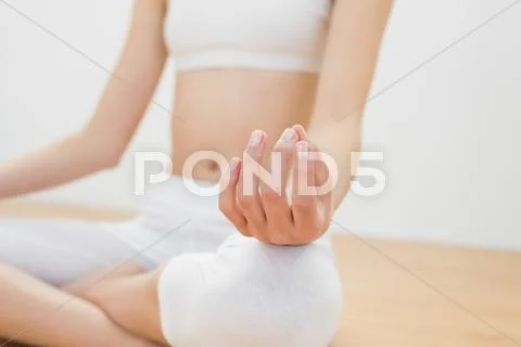 Close up of slender woman meditating sitting in lotus position Stock Photos