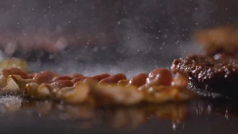 Close-up of a slice of bacon fried on a hot grill Stock Footage 121701887