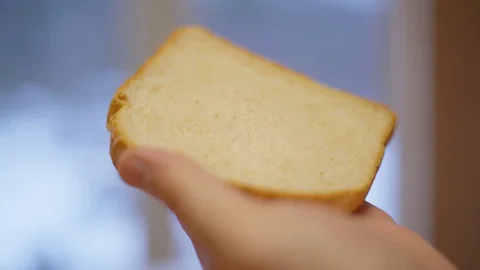 Close up slice of bread and knife smearing of peanut butter Video stock 127977224