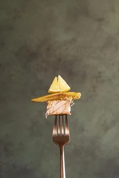 Close-up slice of cooked salmon steak on a fork. Stock Photos