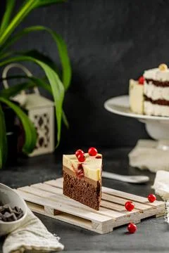 Close up of a slice of delicious cake with red currant and cheesy whipped cream Stock Photos