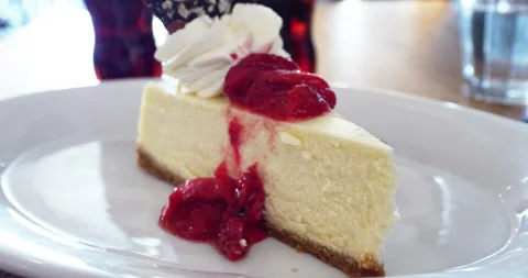 Close-up of a slice of a delicious cheesecake served with whipped zoom out Stock Footage 153021517