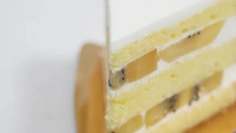 Close Up Slice of Fresh Fruit Sponge Cake with Whipped Cream Stock Footage 343020655