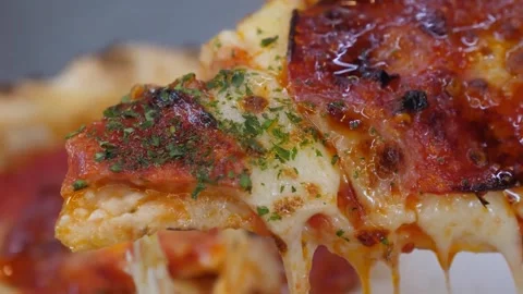 Close-up of a slice of fresh hot Italian pizza with melting, dripping mozzarella Stock Footage 337676683
