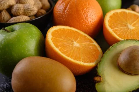 Close up with Slice of fresh orange apple, kiwi, peanut, and avocado. Stock Photos