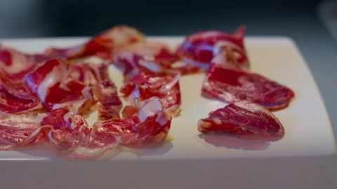 Close up of a slice of ham, of excellent quality, with chef's Cutting Board. Video stock 159339418