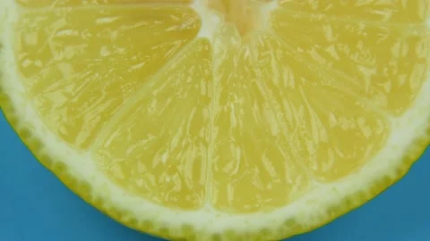 Close up slice of lemon swirls on a blue background Stock-Footage 138894912