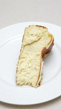 Close-up of a slice of New York-style cheesecake on a white plate. Stock Photos