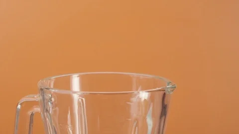 Close-up of slice of peeled pineapple flying in blender in slow motion Video stock 125124309