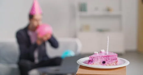 Close-up of slice of pink birthday cake with candle lies on white plate stands Stock Footage 150064209