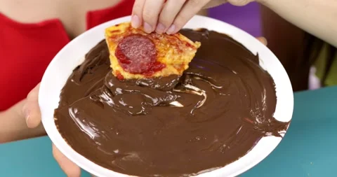 Close-up of a slice of pizza dipped in chocolate Stock Footage 161875429
