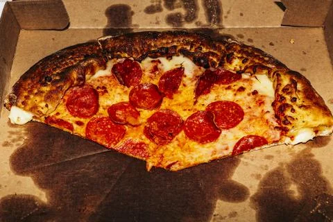 A close up of a slice of pizza Stock Photos
