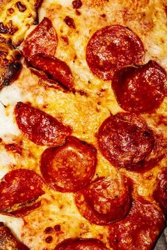 A close up of a slice of pizza Stock Photos