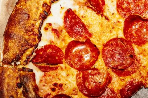 A close up of a slice of pizza Stock Photos
