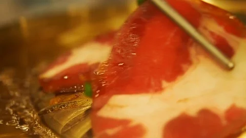 Close-up of a slice of pork fried on a hot grill. Stock Footage 94165148