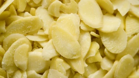 Close up of sliced almonds rotating. Flat plane. Top view Stock Footage 104639717