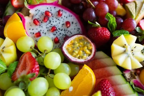 Close up sliced assorted fresh tropical fruits platter,use a background Stock Photos