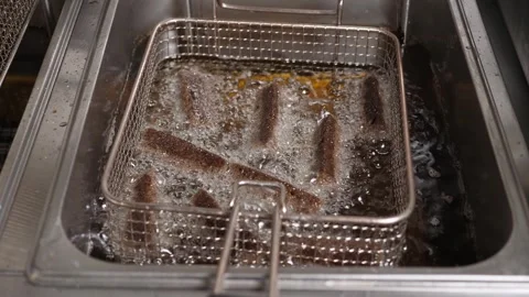 Close-up of sliced black bread fried in boiling oil deep-fried in the kitchen. Stock Footage 287588377