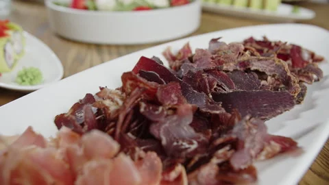 Close Up of Sliced Cured Meat on Serving Plate Stock Footage 301528333