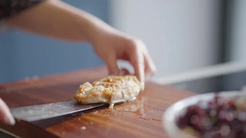 Close Up of Sliced Grilled Chicken Being Added to Fresh Salad Stock Footage 336466891