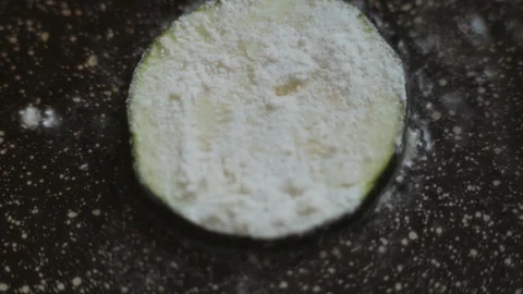 Close-up, sliced pieces of zucchini fried in oil in a pan Stock Footage 337112960