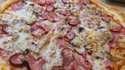 Close-up of Sliced Pizza with Ham and Mushrooms Stock Footage 318801177