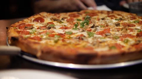 Close up on a sliced pizza on a paddle Stock Footage 101220369