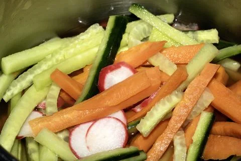 Close Up of Sliced Vegetables being Pickiled Carrot Radish and Cucumber Stock Photos