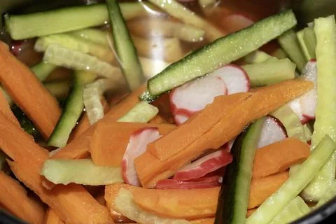 Close Up of Sliced Vegetables being Pickiled Carrot Radish and Cucumber Stock Photos