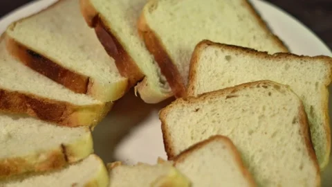 Close Up of Sliced White Bread Pieces on a Plate for Breakfast or Snack. Stock Footage 331030728