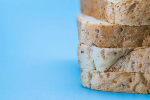 Close up of sliced whole wheat bread on blue background Stock Photos