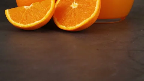 Close up of slices of orange and squeezed orange juice Stock Footage 130880472