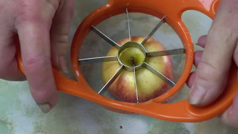 Close-up slicing an apple with an apple cutter Video stock 141038947