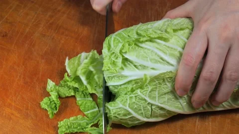 Close-up of slicing Chinese cabbage slow mo Stock Footage 149073433