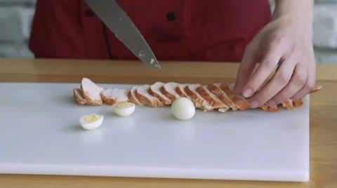 Close up of slicing eggs and meat on white board on the kitchen. Slowly 動画素材 61963407