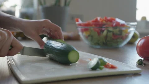 Close-Up Of Slicing Fresh Cucumber On Cutting Board For Healthy Vegetable Salad Stock Footage 308454611