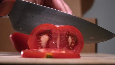 Close up of slicing fresh tomato, slow motion. Stock Footage 154713029