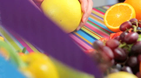 Close up slicing grapefruit in colorful kitchen scene Stock Footage 42181127
