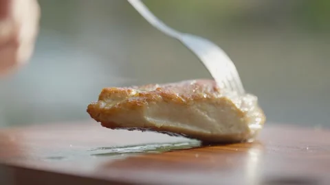 Close Up of Slicing Grilled Chicken Breast with Fork and Knife Stock Footage 336466844
