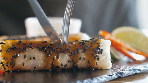Close-up of slicing original asian spring roll, close-up. Stock Footage 121467069
