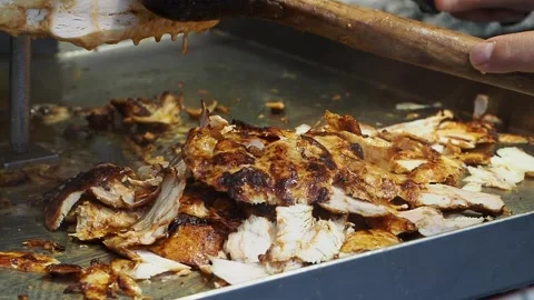 Close-up of slicing roasted chicken meat for shawarma Stock Footage 336882416