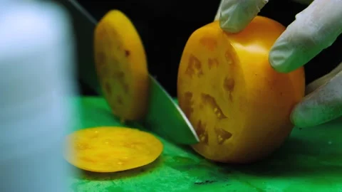 Close up, slicing tomato on the chopping block and preparing them to make tomato Stock Footage 138793472