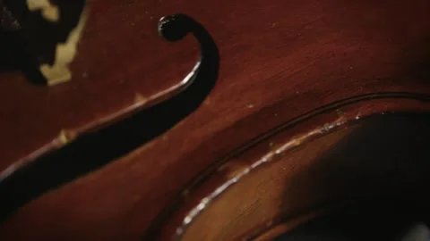 Close-up slide, antique classical violin reveals Acoustic F-Hole shape Vidéo 314326148