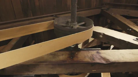 Close-up slider shot of belts and gears operating in corn mill. Stock Footage